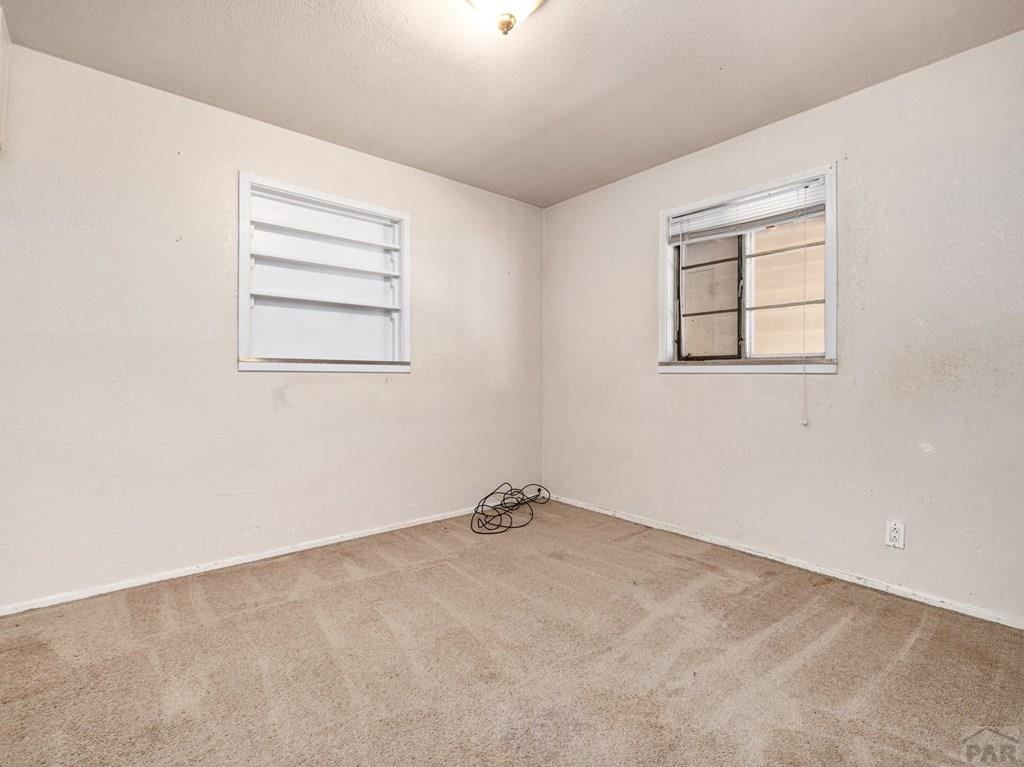 2610 Azalea Street Pueblo, CO 81005 - Photo 12 of 19 an empty room with windows