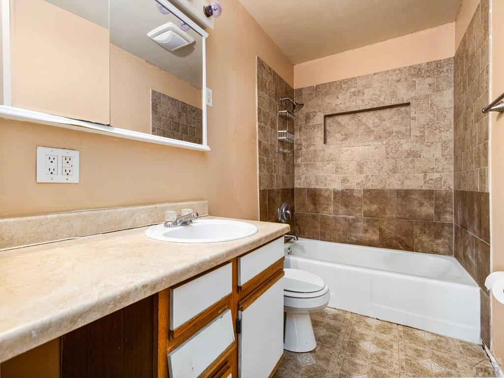 2610 Azalea Street Pueblo, CO 81005 - Photo 14 of 19 a bathroom with a sink a toilet and a bathtub