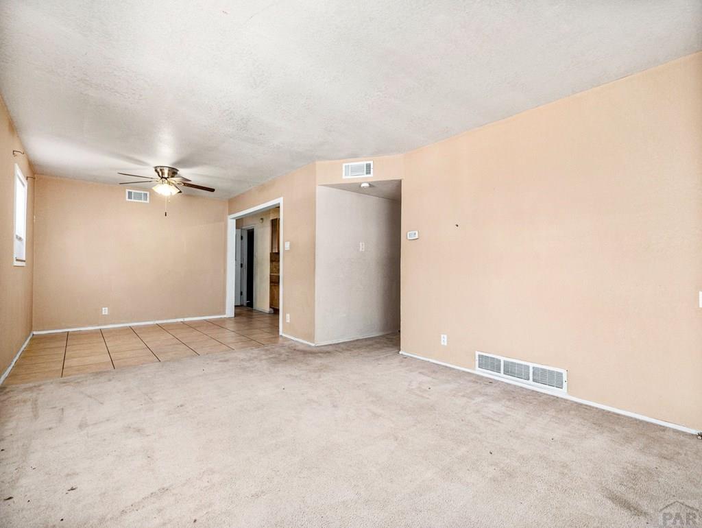 2610 Azalea Street Pueblo, CO 81005 - Photo 4 of 19 an empty room with closet and a ceiling fan