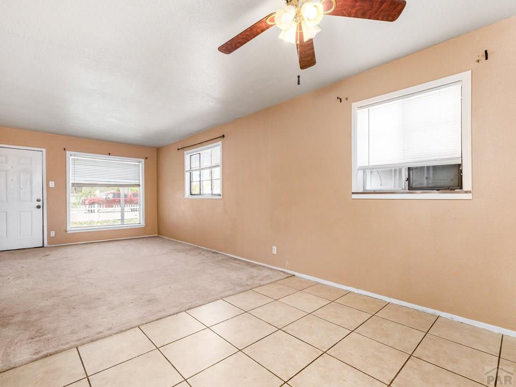 2610 Azalea Street Pueblo, CO 81005 - Photo 6 of 19 a view of an empty room with a window