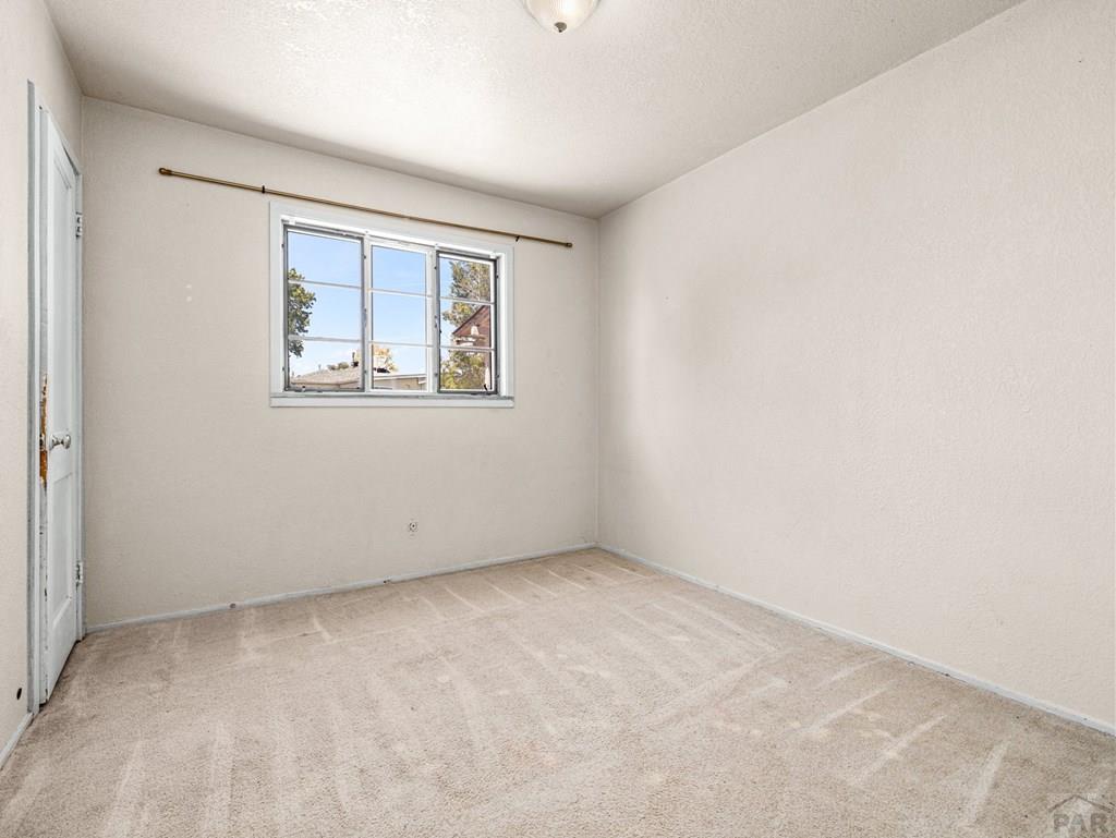 2610 Azalea Street Pueblo, CO 81005 - Photo 8 of 19 an empty room with windows