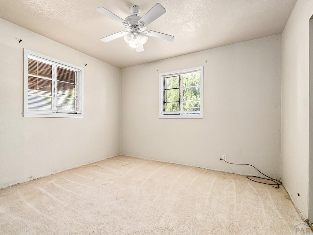 2610 Azalea Street Pueblo, CO 81005 - Photo 10 of 19 an empty room with windows