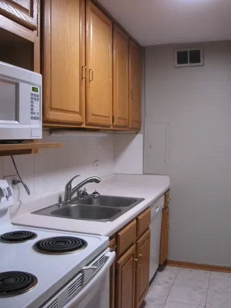 a kitchen with a sink and a stove top oven