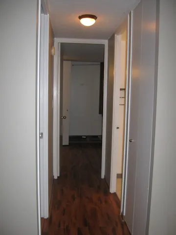 a view of front door with wooden floor