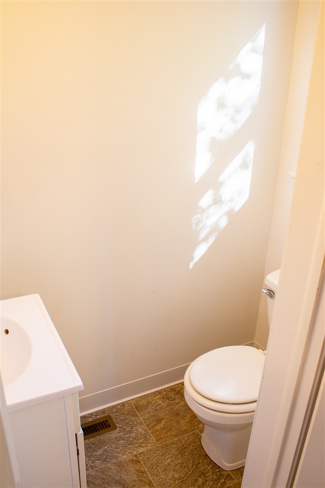 2017 Rural Street Rockford, IL 61107 - Photo 10 of 21 a white toilet sitting next to a white sink and vanity