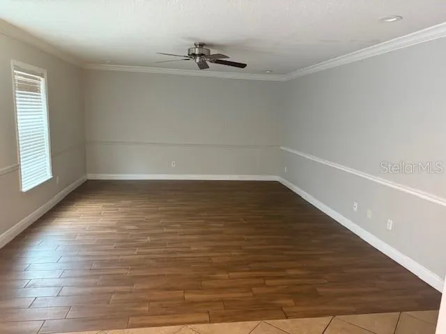 a view of a room with wooden floor and white walls