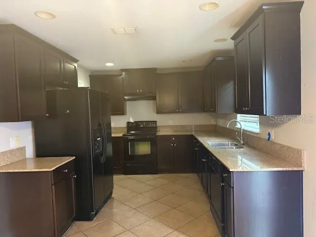 a kitchen with a sink and a refrigerator