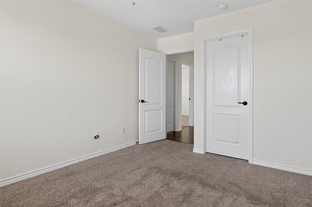8728 Maple Ridge Trail Fort Worth, TX 76244 - Photo 36 of 40 Neutral-toned carpeting and light-colored walls create an inviting atmosphere
