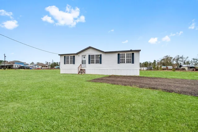 a view of a house with a backyard
