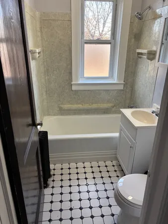 a bathroom with a toilet a sink and a bathtub