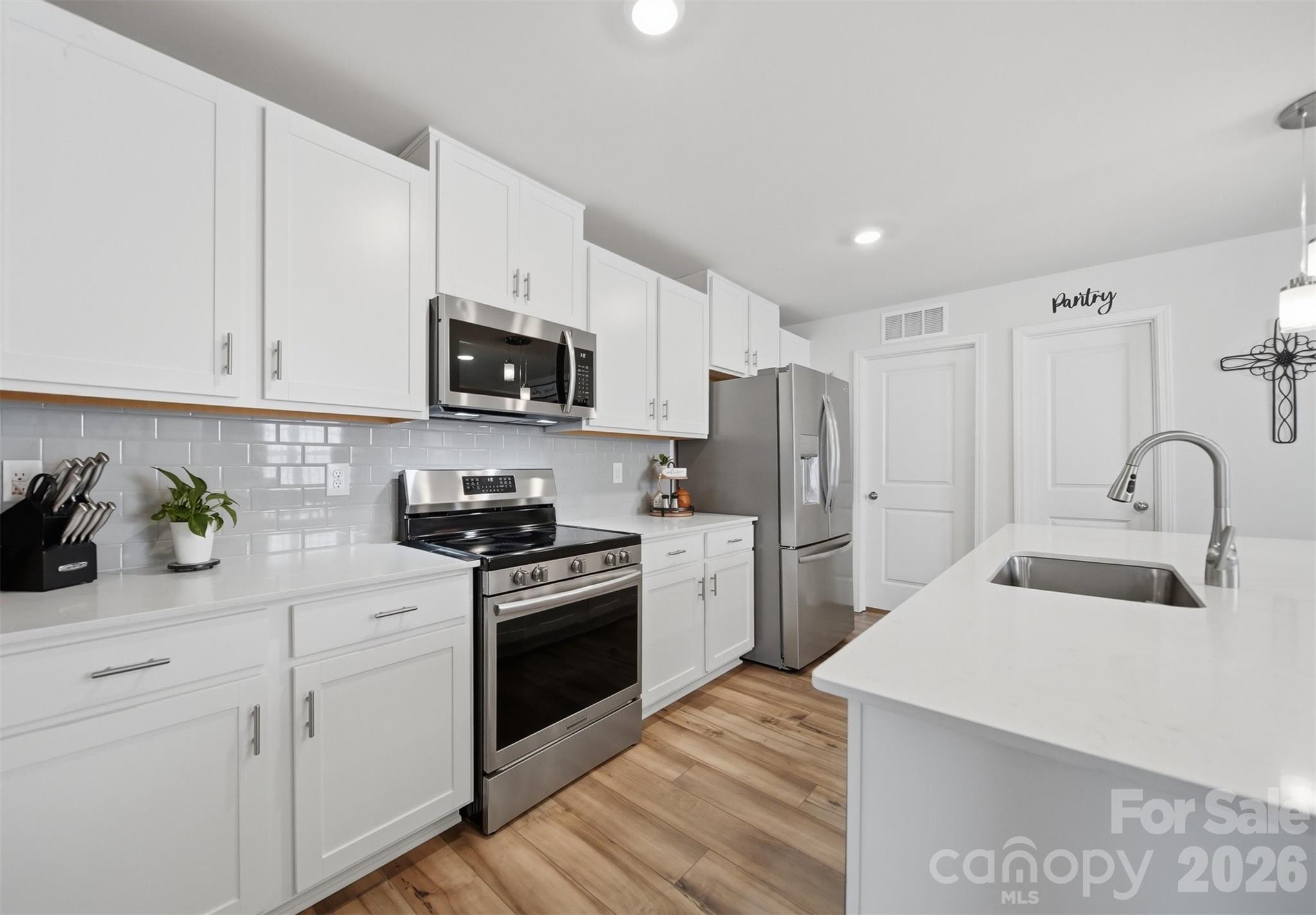 2841 Legacy Rdg Lane Catawba, NC 28609 - Photo 12 of 42 a kitchen with white cabinets and stainless steel appliances