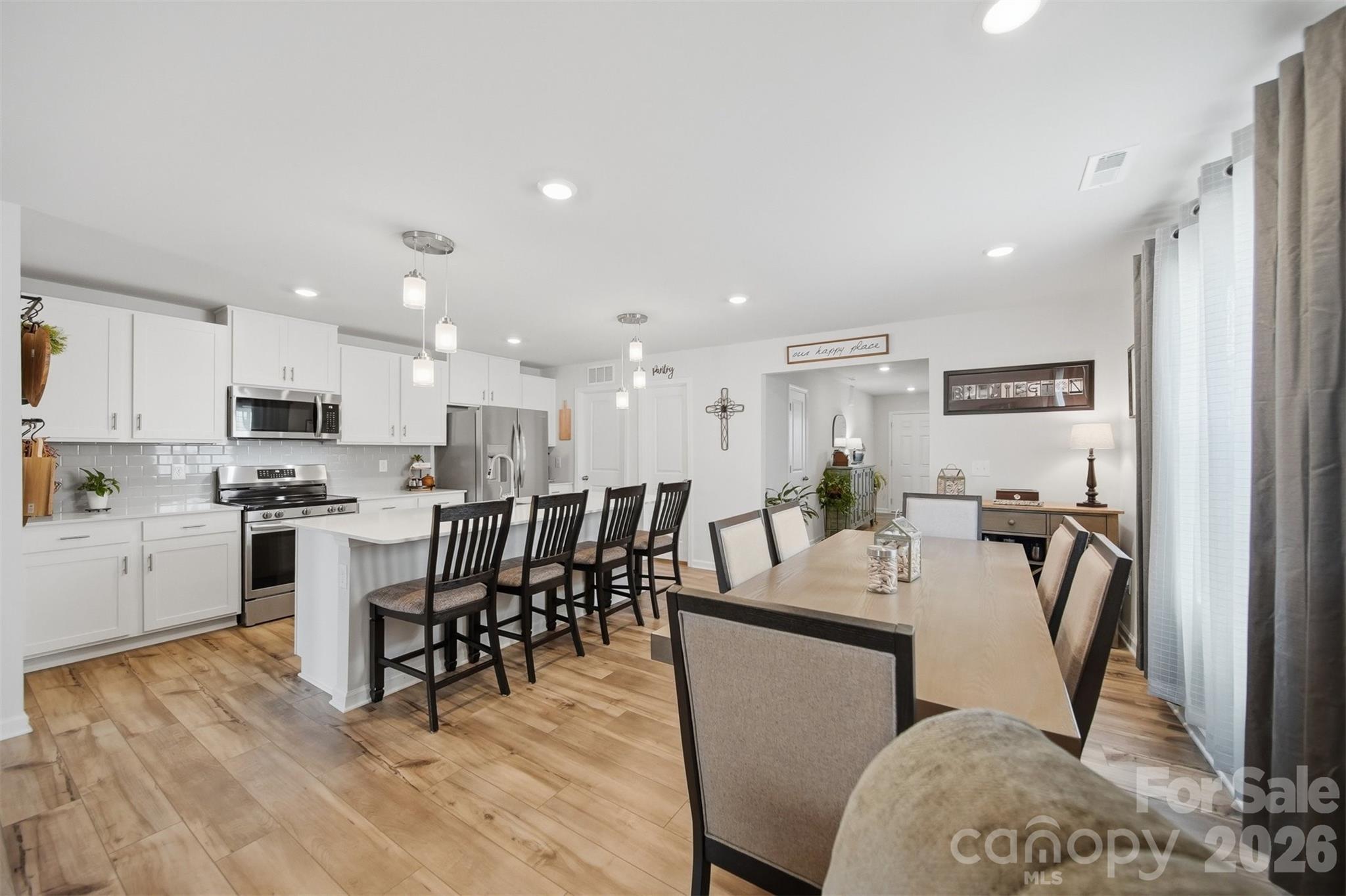 2841 Legacy Rdg Lane Catawba, NC 28609 - Photo 9 of 42 a kitchen with a dining table chairs appliances and cabinets
