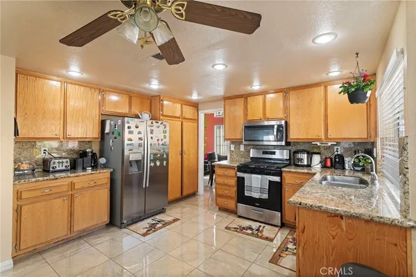 a kitchen with stainless steel appliances granite countertop a refrigerator oven stove top oven a sink and dishwasher