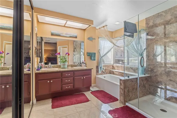 a bathroom with a tub sink and mirror