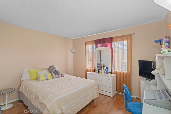 a bedroom with a bed and flat screen tv