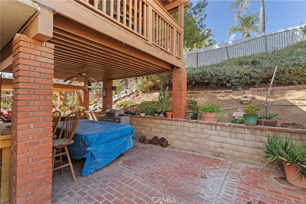 a view of a porch with furniture and a yard