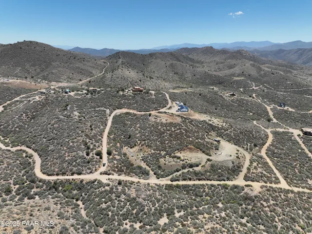 a view of a dry yard with mountains in the background