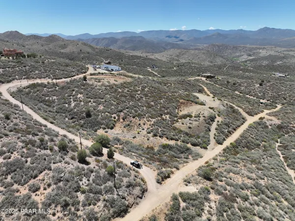 a view of a mountain range with lush green hillside