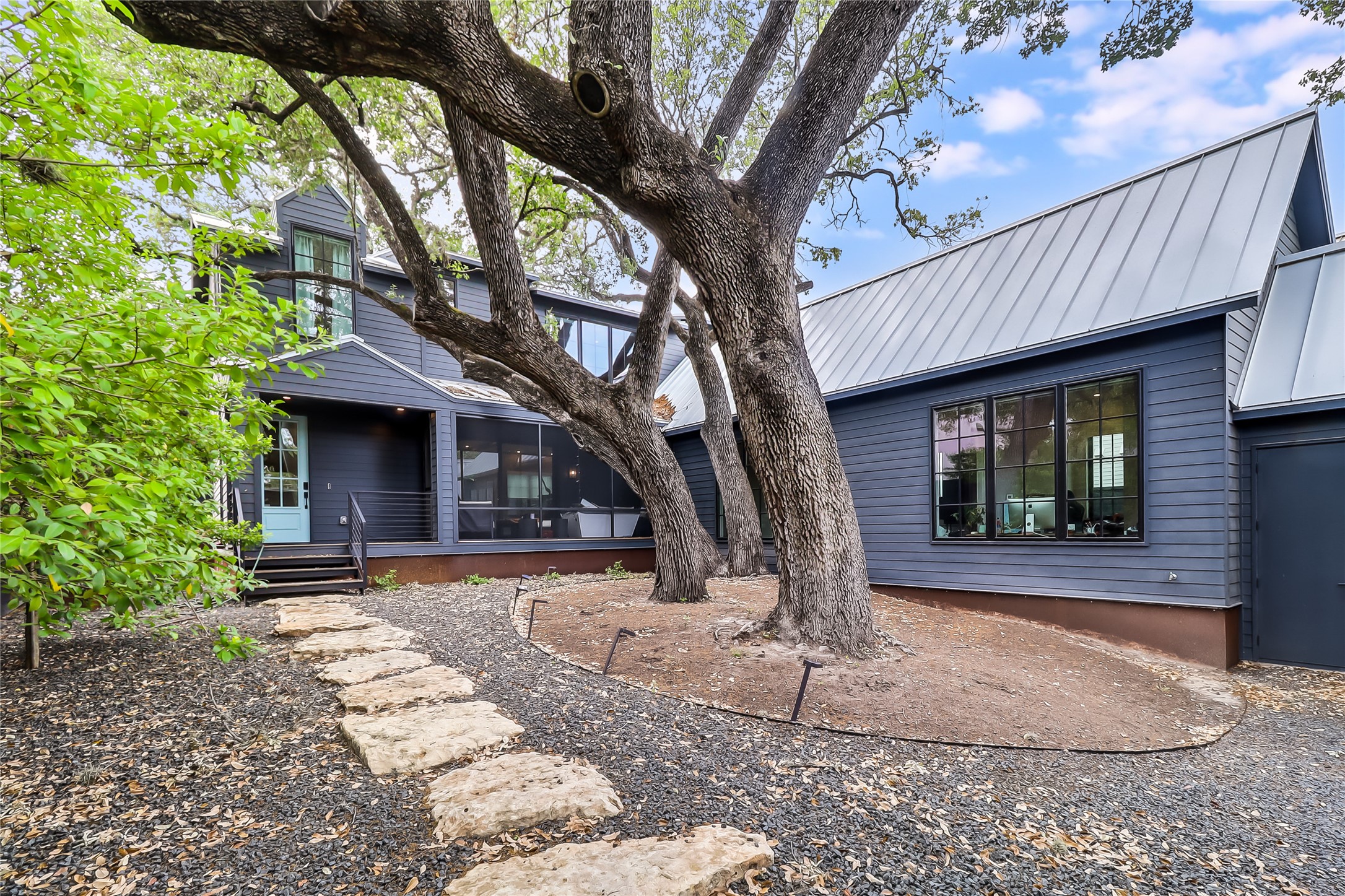 1402 Drake Avenue Austin, TX 78704 - Photo 1 of 1 Front view of house featuring a standing seam roof, metal roof, and a sunroom