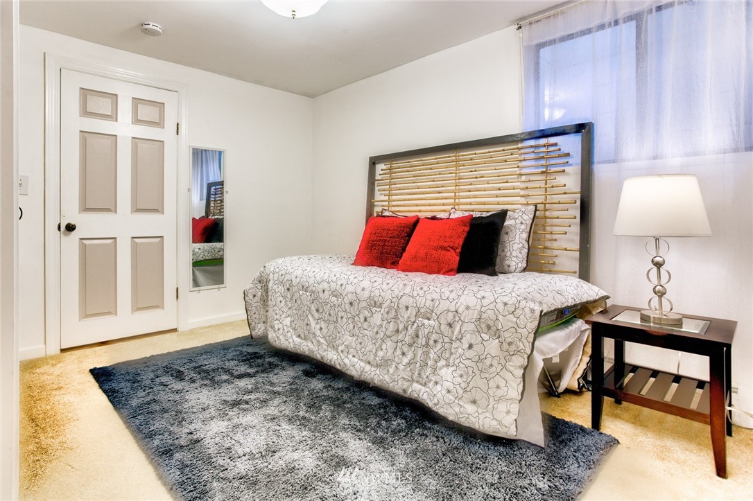 2347 North 64th Street Seattle, WA 98103 - Photo 15 of 25 a bedroom with a bed and a lamp on table