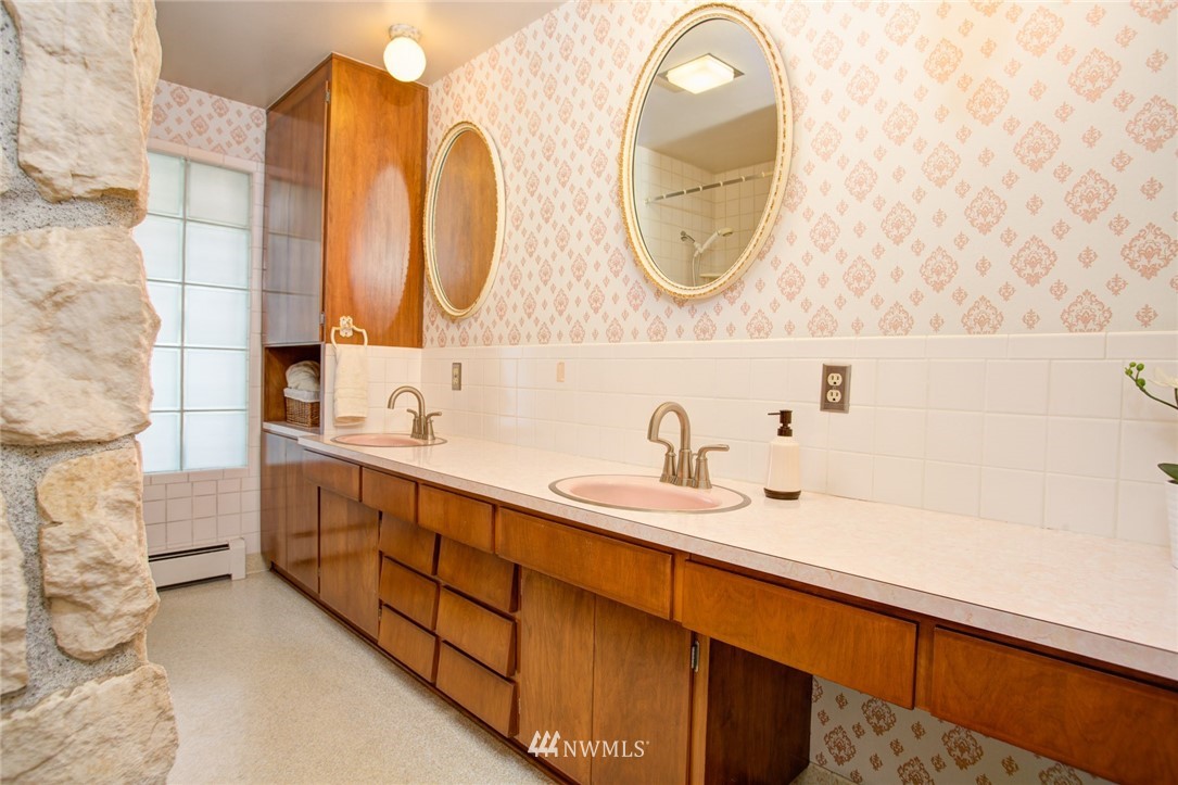 2347 North 64th Street Seattle, WA 98103 - Photo 17 of 25 a bathroom with a double vanity sink and a mirror
