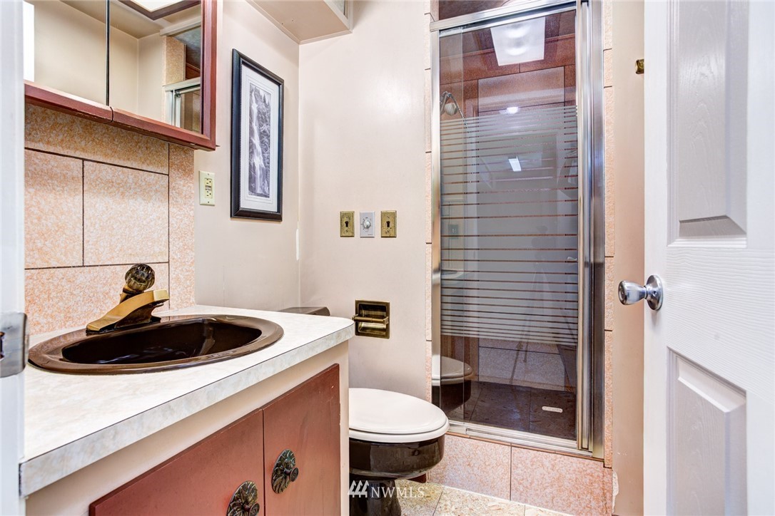2347 North 64th Street Seattle, WA 98103 - Photo 18 of 25 a bathroom with a sink a toilet and shower
