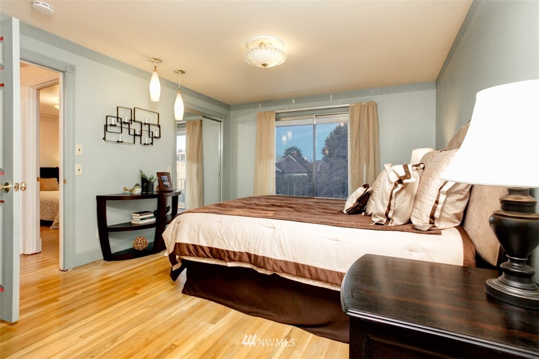 2347 North 64th Street Seattle, WA 98103 - Photo 8 of 25 a bedroom with a bed and wooden floor