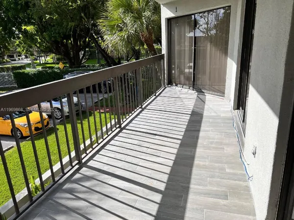 a view of a balcony with wooden floor