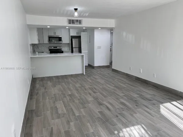 a view of kitchen with microwave and stove