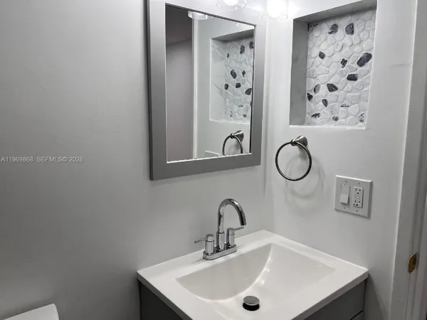 a bathroom with a sink and a mirror