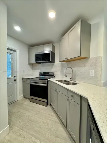 a kitchen with granite countertop a stove and a sink