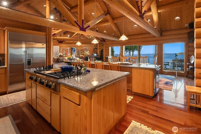 a kitchen with stainless steel appliances granite countertop a stove a sink and a refrigerator