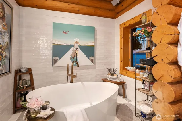 a bathroom with a tub sink and mirror
