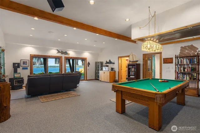 a living room with furniture a table and kitchen view