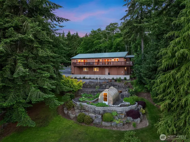 a front view of a house with swimming pool and garden