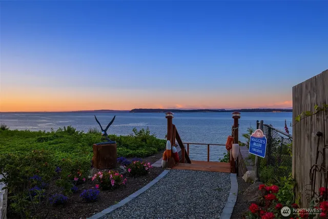 a front view of a house with a yard table and chairs