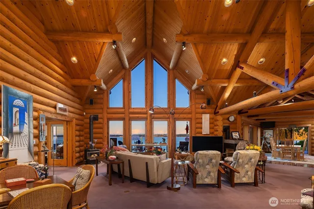 a living room with furniture a chandelier and a projector