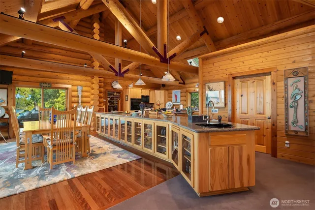 a kitchen with stainless steel appliances granite countertop a stove and a view of living room