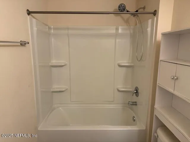 a bathroom with a shower and a bath tub