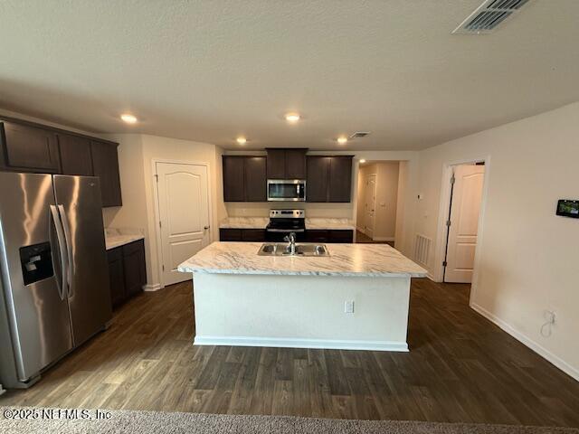 828 Morgans Treasure Road St. Augustine, FL 32084 - Photo 20 of 21 a view of kitchen with stainless steel appliances granite countertop a stove a refrigerator a sink and a oven with wooden floor