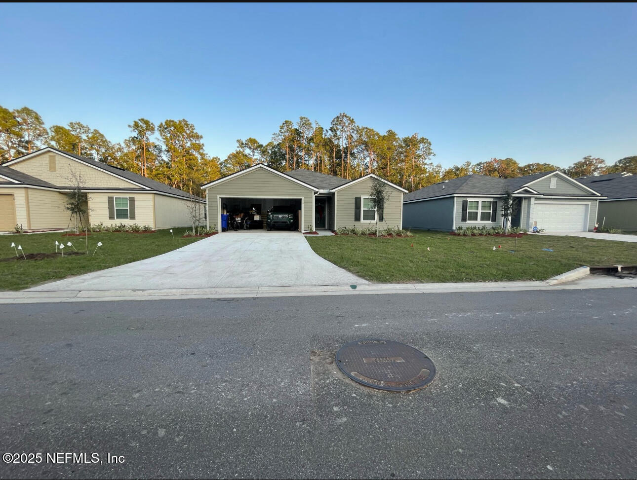 828 Morgans Treasure Road St. Augustine, FL 32084 - Photo 2 of 21 a front view of a house with a yard and garage