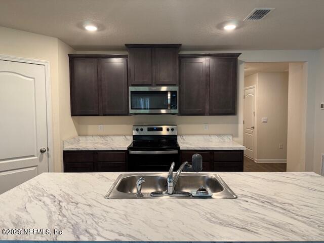 828 Morgans Treasure Road St. Augustine, FL 32084 - Photo 4 of 21 a kitchen with a stove a refrigerator and a sink