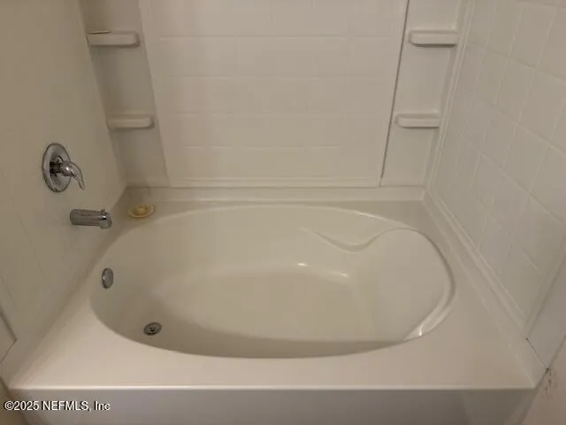 a white bath tub sitting in a bathroom
