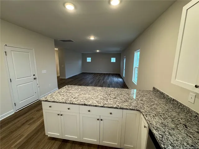 a kitchen with granite countertop white cabinets and a granite counter tops