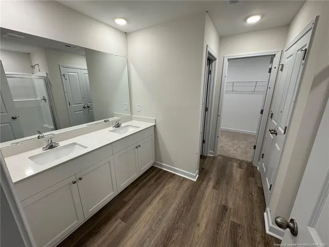 a bathroom with a double vanity sink and mirror