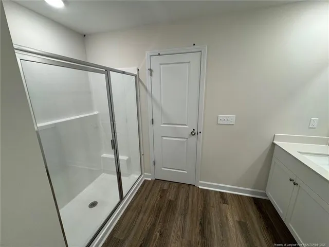 a bathroom with a sink and shower
