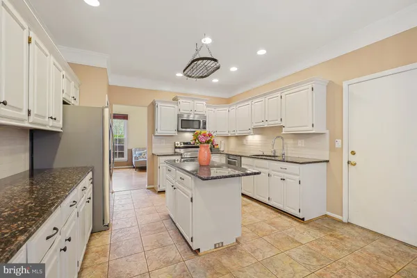 a kitchen with granite countertop a sink and cabinets