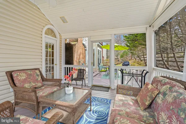 a living room with furniture and floor to ceiling windows