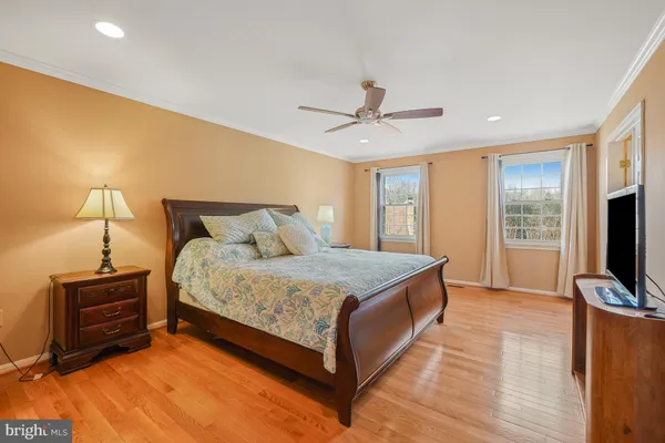 a bedroom with a bed flat screen tv and window