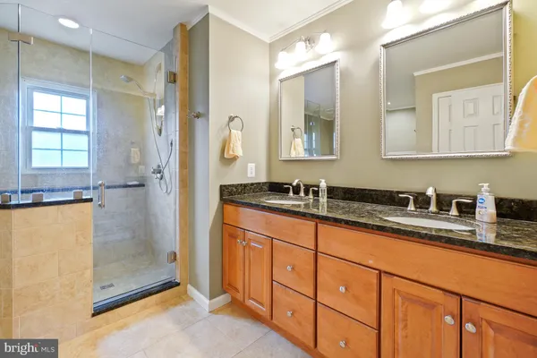 a bathroom with a granite countertop sink mirror and double